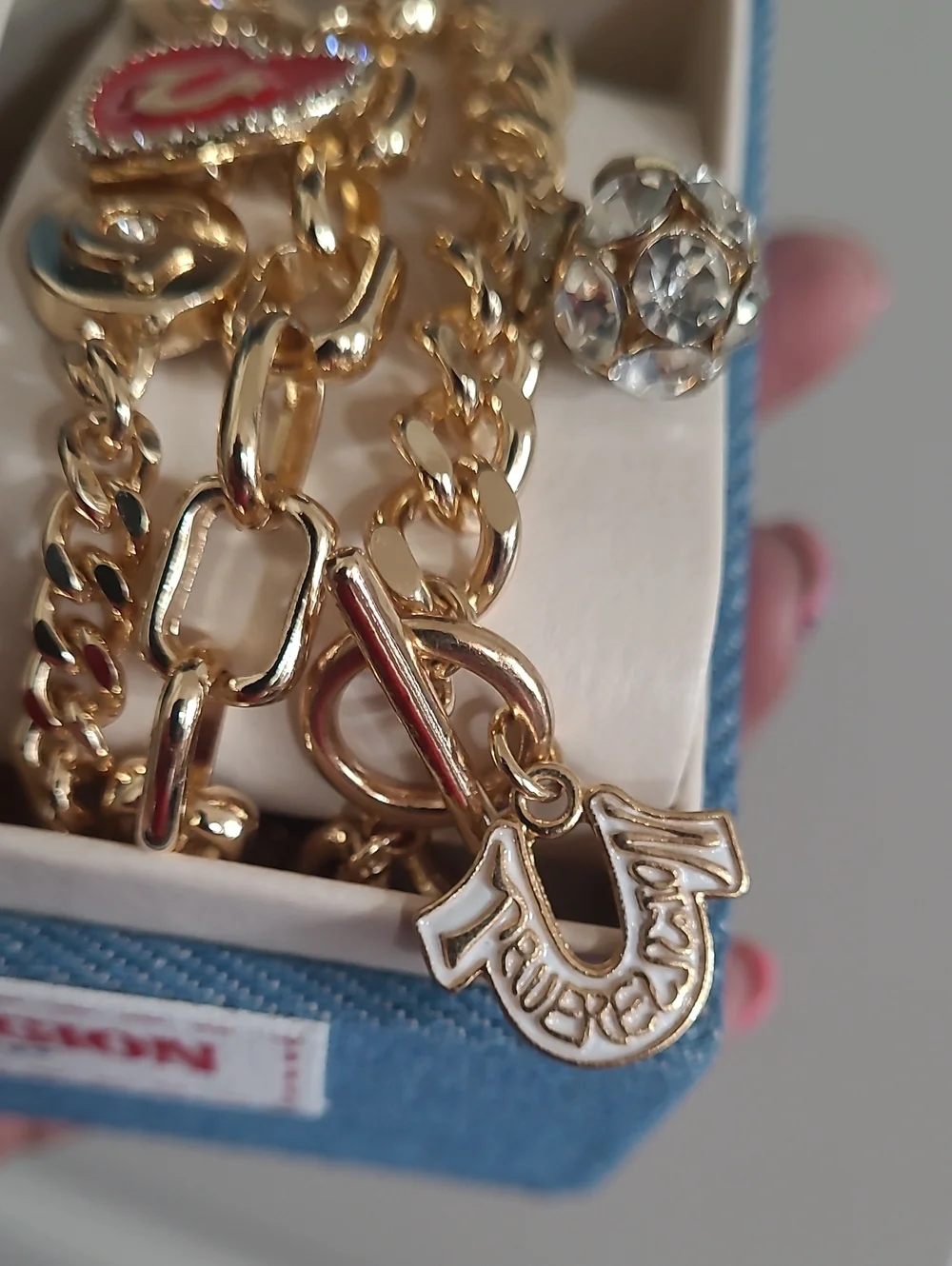 True Religion Gold-Tone Watch with Black Dial and Charm Bracelet